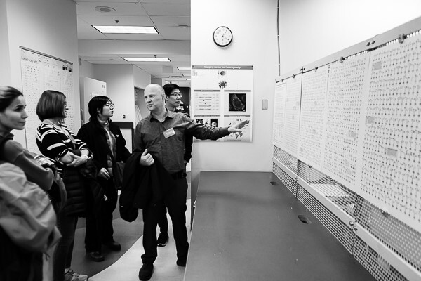 Our Interim Co-Director and Group Leader for Biospecimen & Library Core, Dr. Andy Mungall leads a tour group during the lunch break through our sequencing facility. Pictured here is Andy describing to Forum guests a graphical representation of complex omic and associated clinical data for the Personalized OncoGenomics program. Photo by Martin Krzywinski.